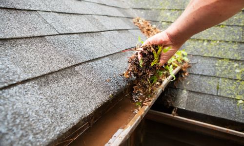 Cleaning gutters by hand