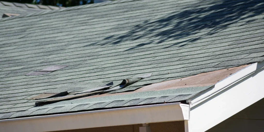 Missing and curled shingles on the roof of a Colorado home. 